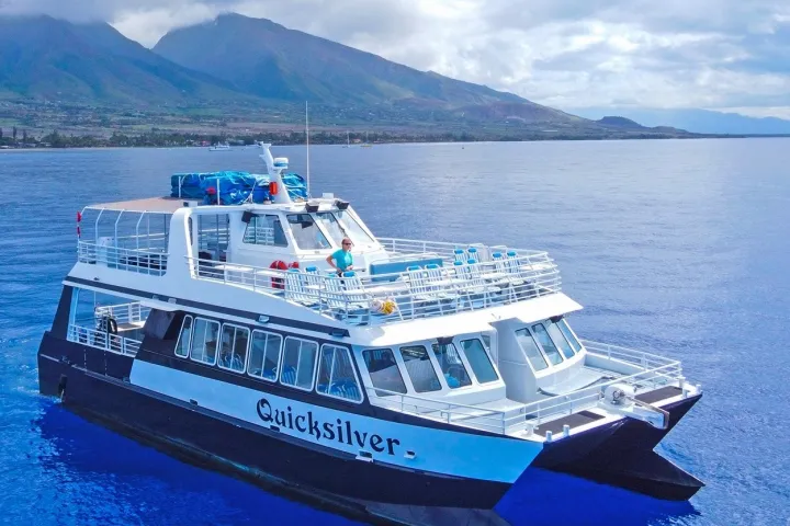 a large blue boat sitting next to a body of water