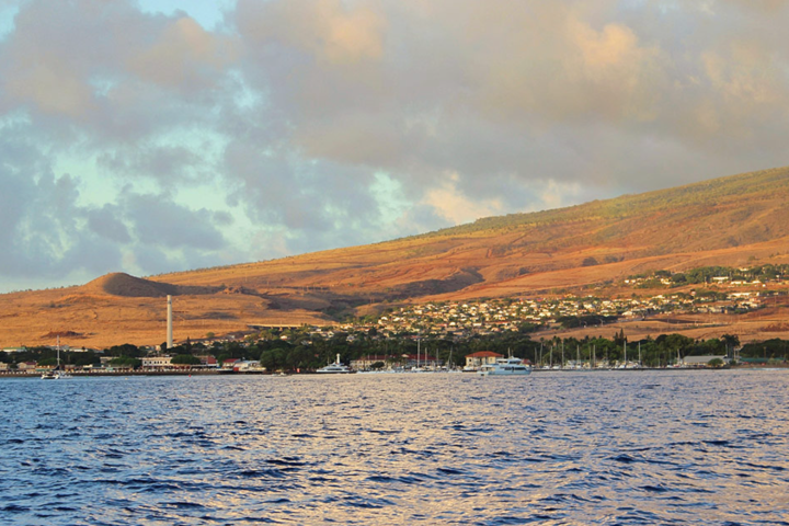 a large body of water with a mountain in the background