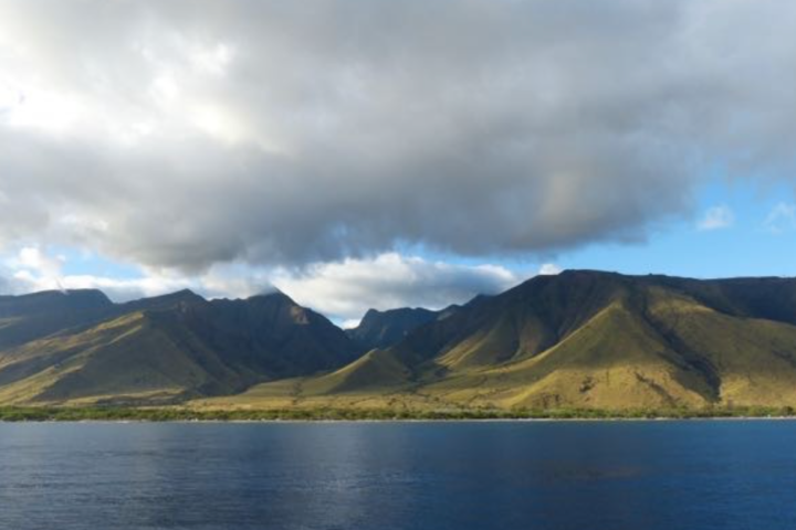 a body of water with a mountain in the background