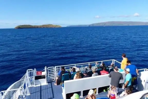 a group of people in a boat on a body of water