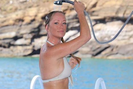 a woman standing next to a body of water