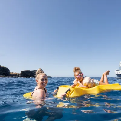 a group of people on a boat in the water
