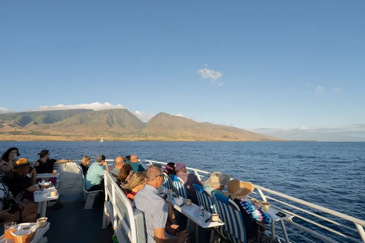 a group of people standing next to a body of water