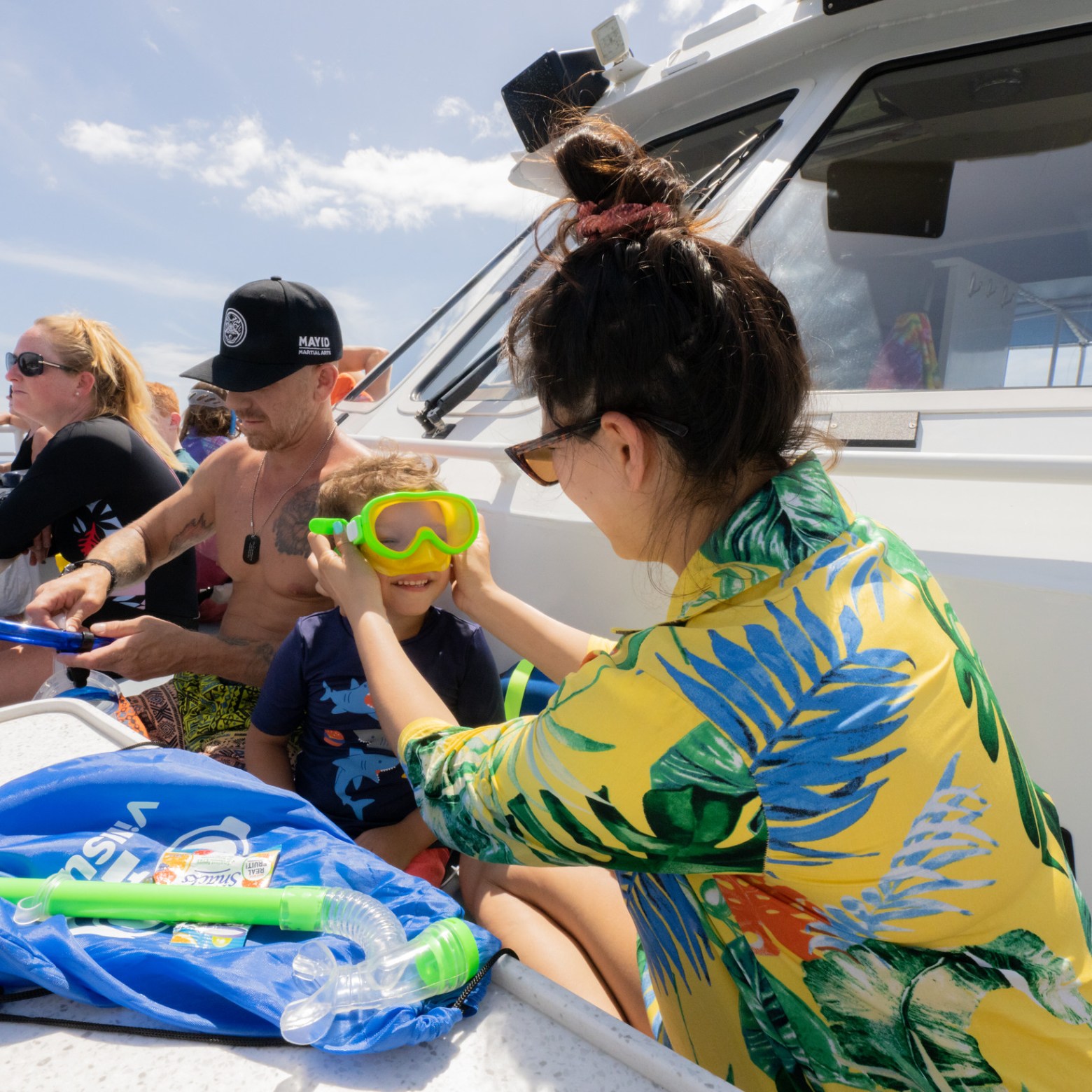 a group of people sitting at a beach