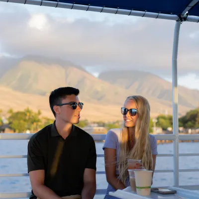 a person sitting on a dock next to a body of water