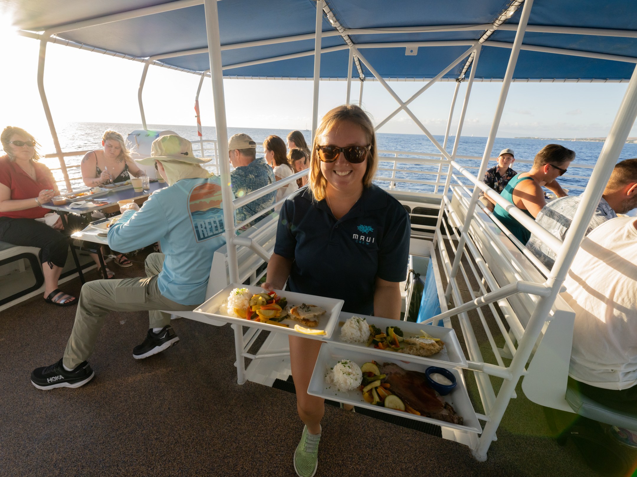 a group of people sitting at a dock