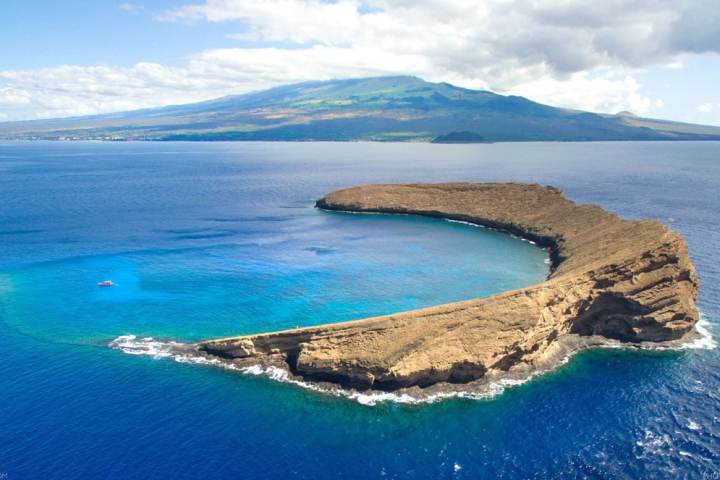 a body of water with a mountain in the background