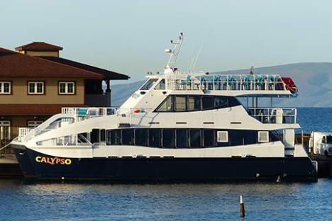 a boat is docked next to a large body of water